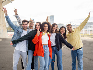 Obraz premium Group of young diverse teenage friends having a good time in the street