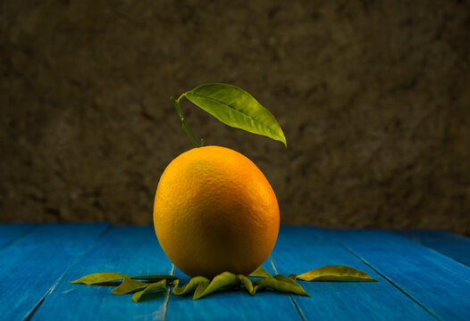 Close-up footage of orange and tangerine fruit on blue background.