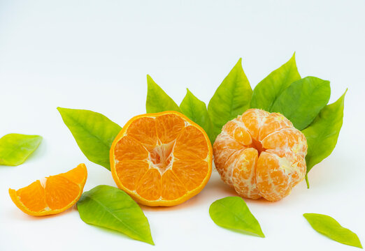 Close-up footage of orange and tangerine fruit on white background.