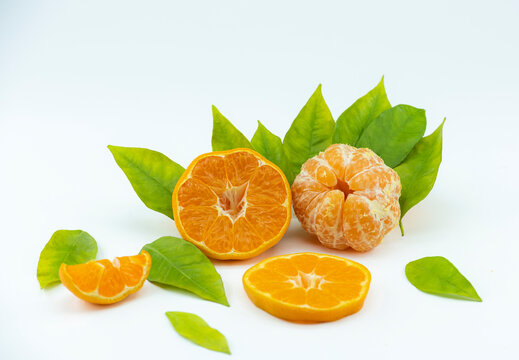 Close-up footage of orange and tangerine fruit on white background.