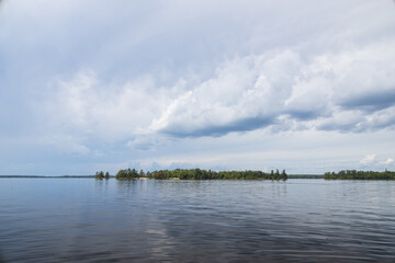 Cloudscape over the forest and lake