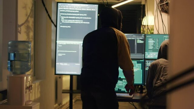 Police stopping criminals to do cyberterrorism and phishing, enforcing government operation maintaining safety. Team of hackers running away from police lights at night, law enforcement.