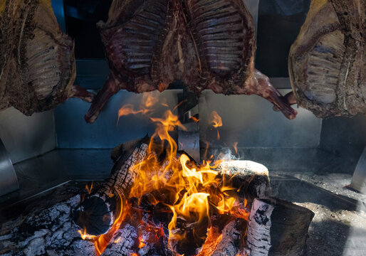 Argentina, Patagonia, El Calafate restaurants offering traditional slow cooked asado parilla grilled meat that includes chorizo beef, kidneys and chicken.