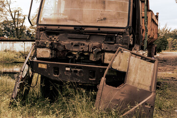 Fototapeta na wymiar Broken old truck that has been badly damaged abandoned in the middle of a park with vintage looks