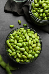 Organic edamame beans on grey table, flat lay