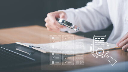 Businessman holding a magnifying glass to show audit documents, quality assessment management With...