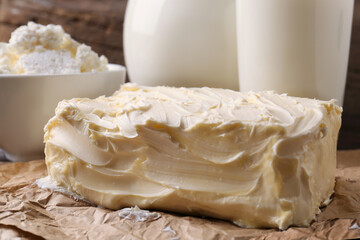 Tasty homemade butter and dairy products on parchment, closeup
