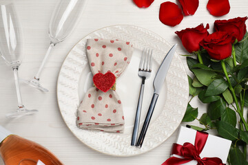 Beautiful table setting with gift box and bouquet for romantic dinner, flat lay