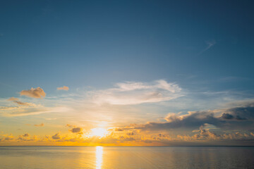 Sea beach with sky sunset or sunrise. Cloudscape over the sunset sea. Dramatic slouds. Sunset at tropical beach. Nature sunset landscape of peaceful calm sea.