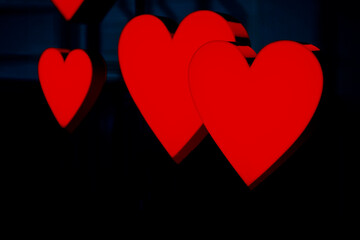 Red hearts decoration . Valentine day decor . Hearts at dark background