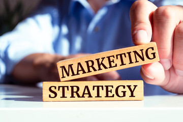 Wooden blocks with words 'MARKETING STRATEGY'. Business concept