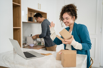 couple woman and man open presents gift in front of laptop computer