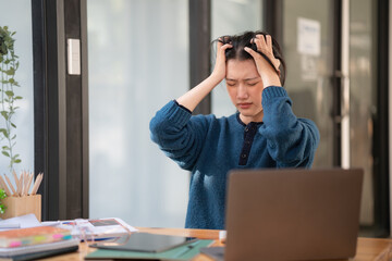 Young Asian businesswomen with office syndrome have a problem with feeling headaches and stress back healthy problems after working on a laptop for a long time. Healthcare, Office syndrome concept