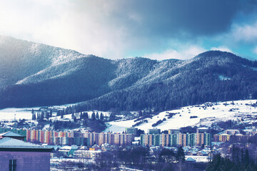 View of a town in winter season.Beautiful snowy mountains in background.