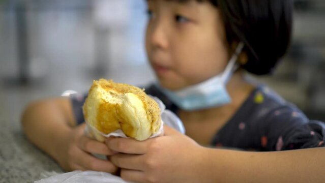Select focus chicken floss bun hold by little girl