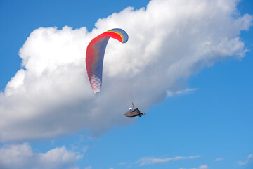 Paramotor sport. man driving a paramotor See the beautiful scenery cloudy sky background extreme sports concept