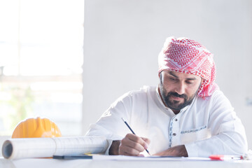 Architect concept, Architects working with blueprints in the office Business accessories (laptop, smartphone, pens, magnifier), accessories for drawing (plans, rulers) and learning on the table