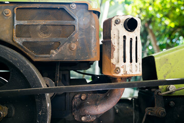 Old walk-behind tractor for agriculture. Exhaust pipe with tractor muffler