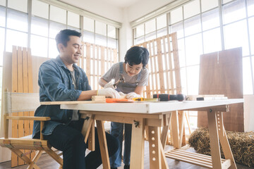 Southeast asian family father and son diy or repair for crafts skill at home workshop