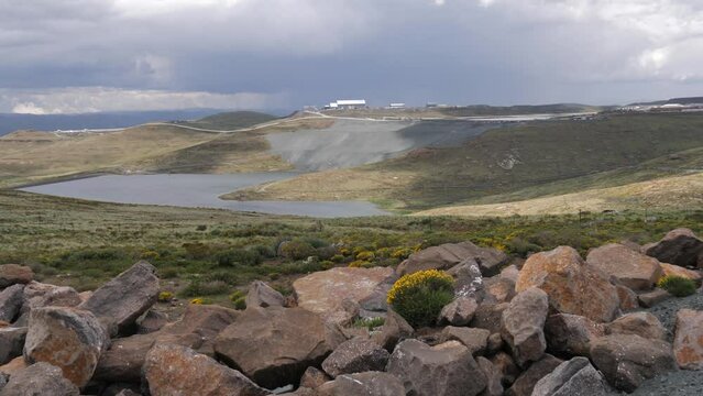 Clouds drift over Letseng Diamond Mine pond in Lesotho, Africa