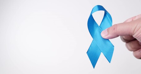 Detail of male hand holding ribbon in Light blue color on white background. Cause ribbons.