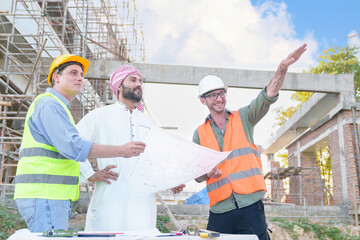 Diverse team of professionals using tablet computers on construction site. Real estate construction project. with civil engineers, architects, Arabic business investors and explorer with theodolite