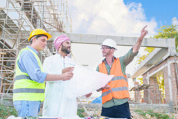 Diverse team of professionals using tablet computers on construction site. Real estate construction project. with civil engineers, architects, Arabic business investors and explorer with theodolite