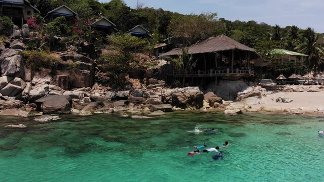 Kids snorkeling at Aew Leuk Beach at Koh Tao in Thailang, filmed with Drone