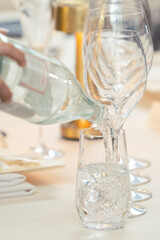 Pouring of sparking water on water glass.