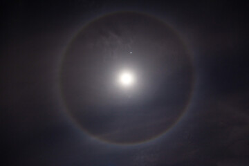 Beautiful Moon Ring , Beautiful winter Halo around the Moon with night sky.