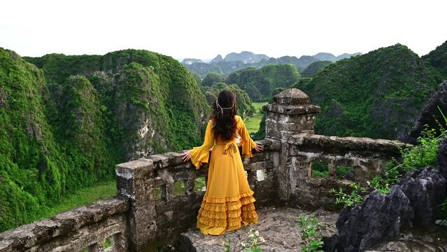 Asian woman  on Hang Mua viewpoint at Tam Coc, Ninh Binh. Vietnam