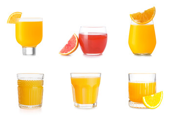 Group of glasses with tasty citrus juice on white background