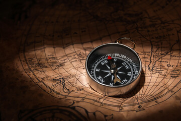 Fototapeta na wymiar Small compass on world map