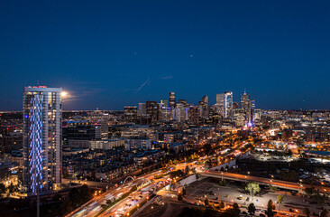 Fototapeta na wymiar Denver at Night with a Full Moon