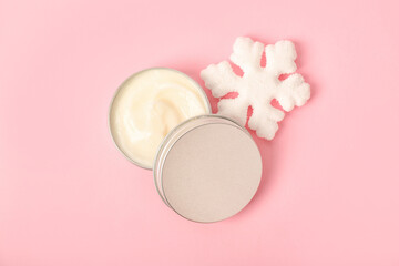 Obraz na płótnie Canvas Jar of cream and Christmas decor on pink background