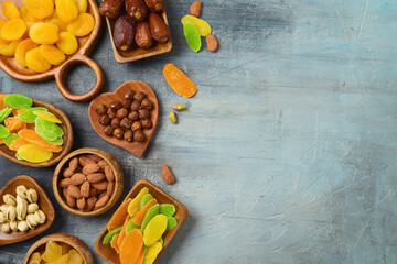 Dried dates, fruits and nuts on rustic background. Top view, flat lay.