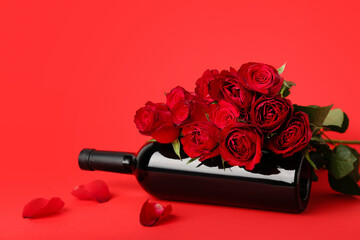 Roses with bottle of wine on red background. Valentine's Day celebration