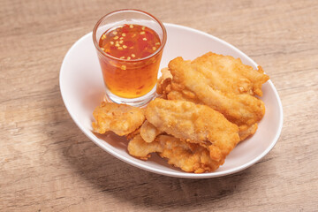 Fried chicken nuggets with dipping sauce in white plate