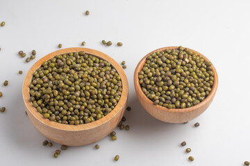 green beans in wooden cup on white background