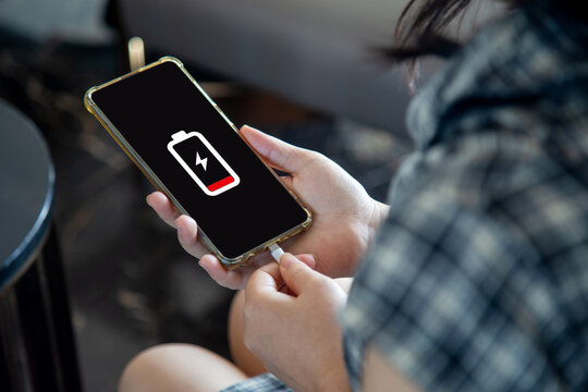 Close Up A Woman Hands Charging Her Mobile Phone With Charging Icon