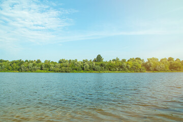 Wide river in the countryside with forest. The surface of the water in the wilderness.