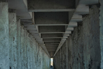 Technical tunnel of stone pillars set near the sea. Part of the coastal infrastructure.