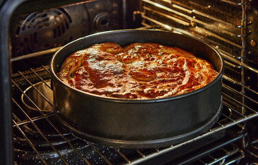 Apple pie in metal mold after baking in the oven