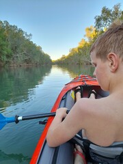 boy kayaking on the lake