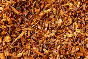 Loose tea rooibos, dry leaves. Close up, macro. Traditional herbal and organic tea.