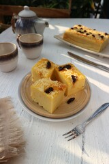 cassava cake with a sprinkling of raisins and cheese