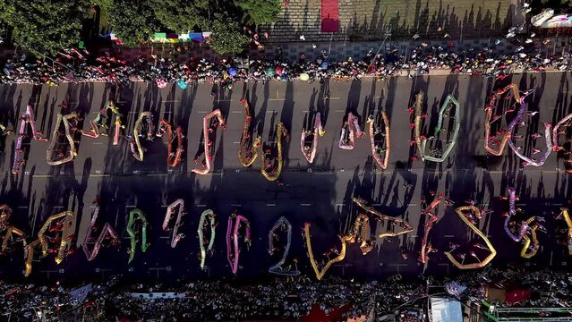 Top view of dragon dance perform celebration new year. Group of people perform a traditional lion dance and dragon dance. Guinness record performance of 54 Dragons dance on the street Vung Tau.