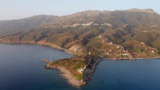 4k drone flight back footage (Ultra High Definition) of Agia Paraskevi Church. Majestic evening scene of Peloponnese peninsula, Greece, Europe. Beautiful summer seascape of Ionian sea.