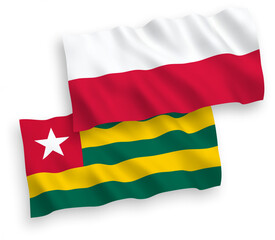 National vector fabric wave flags of Togolese Republic and Poland isolated on white background. 1 to 2 proportion.