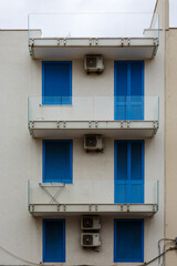 Fototapeta na wymiar Balconly and blue shutters in Polignano a Mare